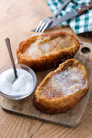 Traditional homemade Spanish torrijas on wooden background. Easter dessertの写真素材