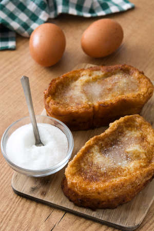Traditional homemade Spanish torrijas on wooden background. Easter dessertの写真素材