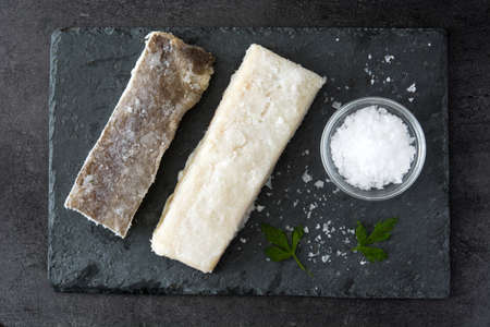 Salted dried cod on black stone. Top view. Typical Easter foodの写真素材