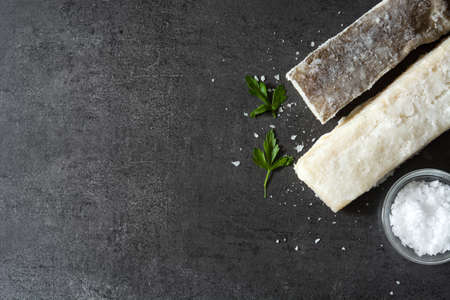 Salted dried cod on black stone. Top view copyspace. Typical Easter foodの写真素材