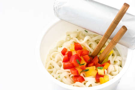 Take away noodles with vegetables isolated on white background. Copyspaceの写真素材