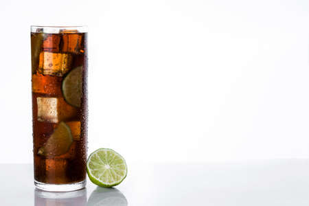 Cuba libre. Cocktail with rum, lime and ice on white background. Copyspaceの写真素材