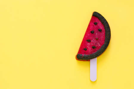 Watermelon popsicle on yellow background. Copyspaceの写真素材