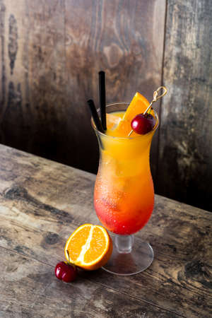 Sex on the beach cocktail in glass on wooden table.の写真素材