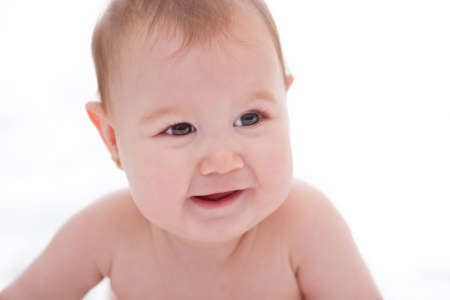 Adorable little baby girl smiling on white background.の写真素材
