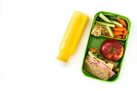 Healthy school lunch: Sandwich, vegetables, fruit and juice isolated on white background. Copyspaceの写真素材