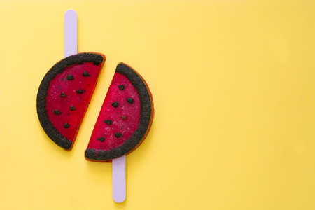 Watermelon icepop on yellow background. Top viewの写真素材