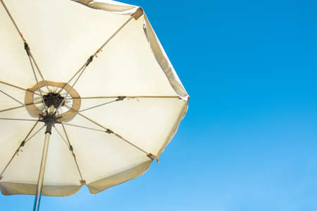 Umbrella and blue summer skyの写真素材
