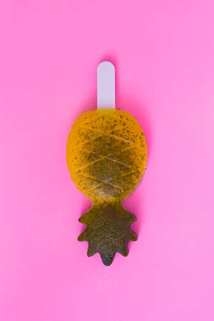 Pineapple ice cream pop on pink background. Top viewの写真素材