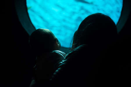 Mather and daughter watching fishes in aquarium. Gran Canaria Spain. May 2018. Poem of the Sea Aquarium.の写真素材