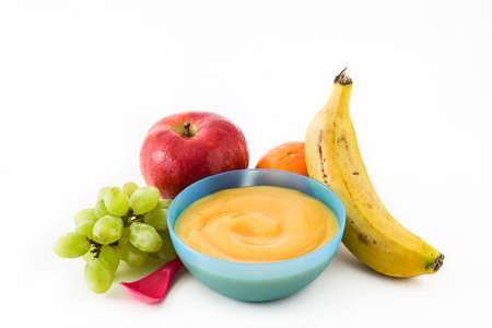Baby food: colorful bowl of fruit puree isolated on white backgroundの写真素材
