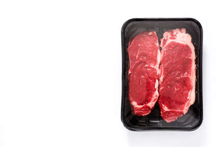 Packing raw beef steak isolated on white background. Top view Copyspace