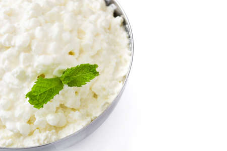 Fresh cottage cheese in a metal bowl isolated on white background. Close up