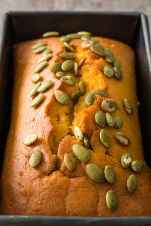 Homemade pumpkin bread on wooden table. Close up