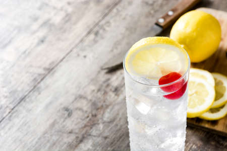 Classic Tom Collins cocktail on wooden table. Copyspaceの写真素材