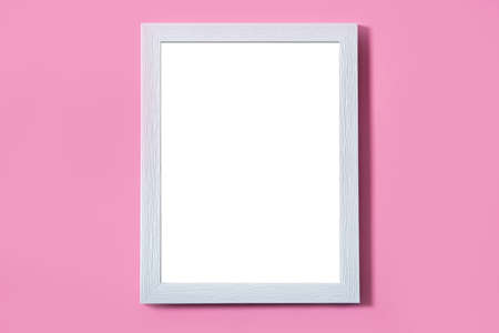 Blank white frame on pink background. Mock up with copy space.の写真素材