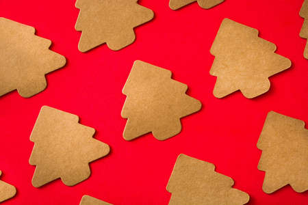 Christmas tree label pattern on red background. Top view
