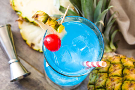 Blue Hawaiian cocktail on wooden table. Top viewの写真素材