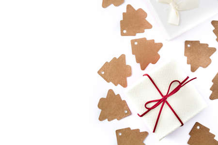 White gift box and christmas tree label on white background. Top view. Copyspace