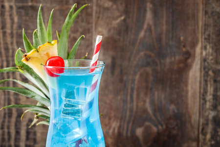 Blue Hawaiian cocktail on wooden table. Copyspaceの写真素材