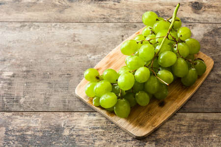 Green grapes on wooden table. Copyspaceの写真素材