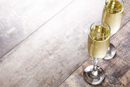 Champagne glasses on wooden table