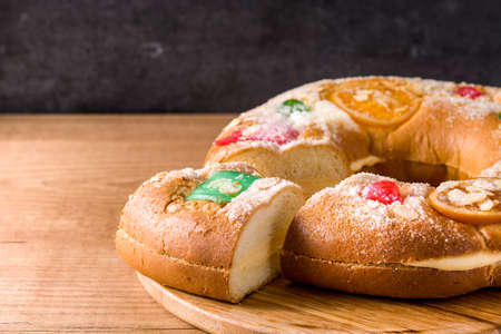 Epiphany cake Roscon de Reyes on wooden table. Copyspace