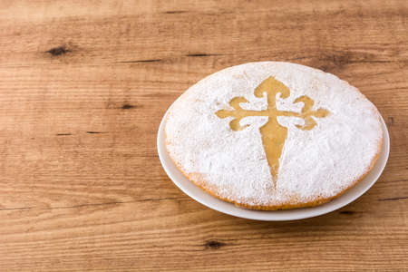 Tart of Santiago. Traditional almond cake from Santiago in Spain on wooden table. Copyspace