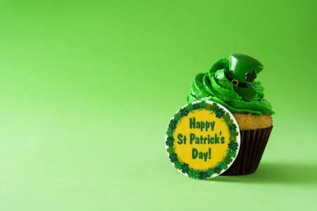 St. Patrick's Day cupcake on green background. Copyspaceの写真素材