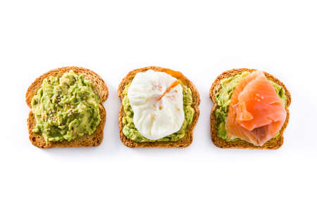 Toasted breads with avocado, poached eggs and salmon isolated on white background. Top view.の写真素材