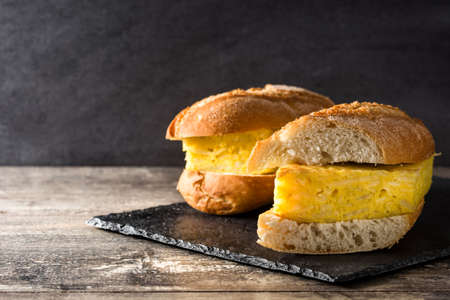 Spanish tortilla sandwich. Spanish potato omelette sandwich on slate background. Copyspace