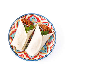 Typical Mexican burritos wraps with beef, beans and vegetables isolated on white background. Top view. Copyspaceの写真素材