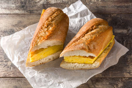 Spanish tortilla sandwich. Spanish potato omelette sandwich on wooden tableの写真素材