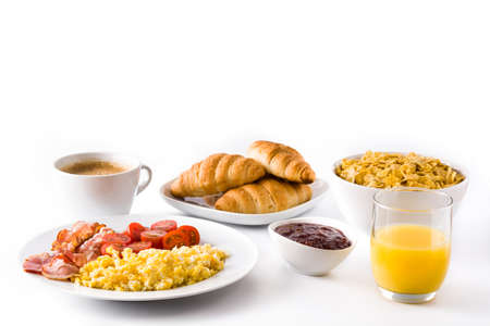 Breakfast with scrambled eggs, bacon, tomatoes, coffee, orange juice, croissant and corn flakes...