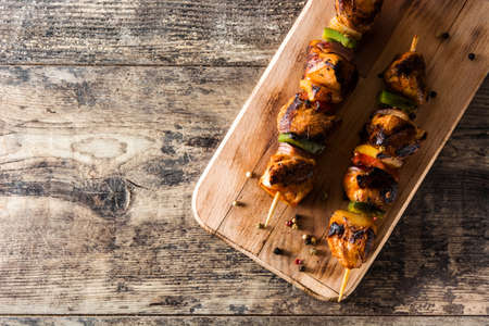 Chicken shish kebab with vegetables on wooden table. Top view. Copyspaceの写真素材