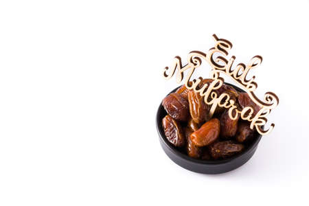 Dates and Eid Mubarak message isolated on white background. Copyspace