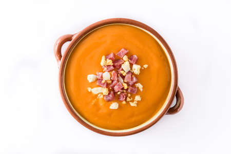 Typical Spanish salmorejo cream with ham and egg isolated on white background. Top viewの写真素材