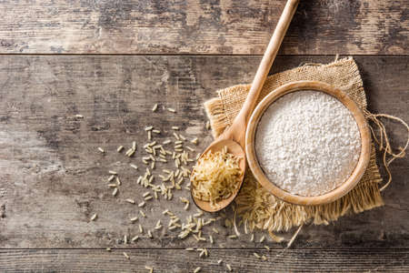 White rice flour in a bowl on wooden table. Top view. Copyspaceの写真素材