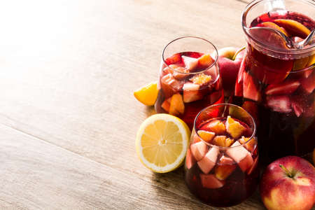 Red wine sangria in glasses on wooden table. Copyspaceの写真素材