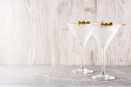 Classic Dry Martini with olives on gray background. Copyspaceの写真素材
