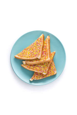 Traditional Australian fairy bread on plate isolated on white background.