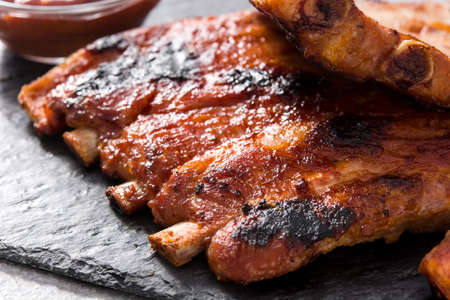 Grilled barbecue ribs on gray stone backgroundの写真素材