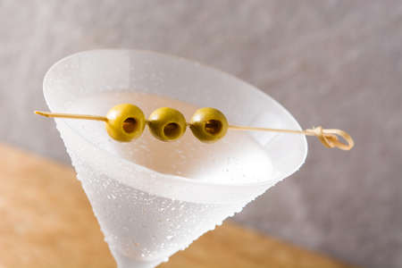 Classic Dry Martini with olives on gray backgroundの写真素材