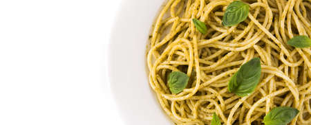 Spaghetti pasta with pesto sauce isolated on white background.Top view. Copy spaceの写真素材