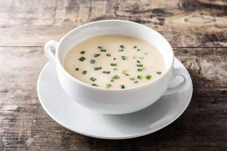 French vichyssoise soup in bowl on wooden tableの写真素材