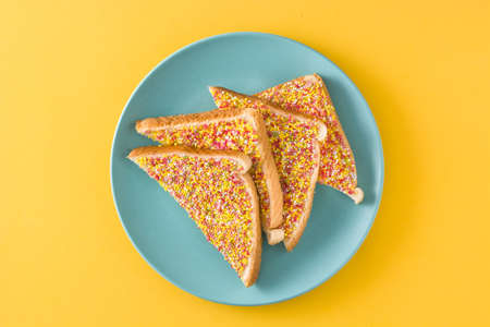 Traditional Australian fairy bread on yellow background. Top viewの写真素材