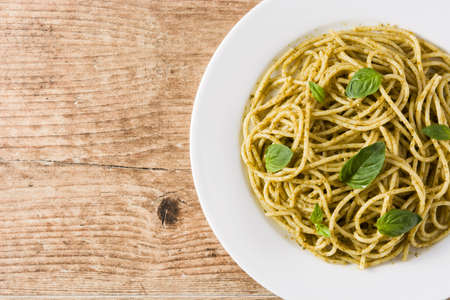 Spaghetti pasta with pesto sauce on wooden table. Top view. Copyspaceの写真素材