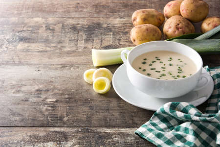 French vichyssoise soup in bowl on wooden table. Copyspaceの写真素材