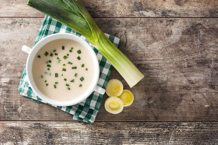 French vichyssoise soup in bowl on wooden table. Top view. Copyspaceの写真素材