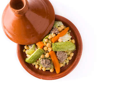 Traditional tajine with vegetables, chickpeas, meat and couscous isolated on white background. Top view. Copyspaceの写真素材